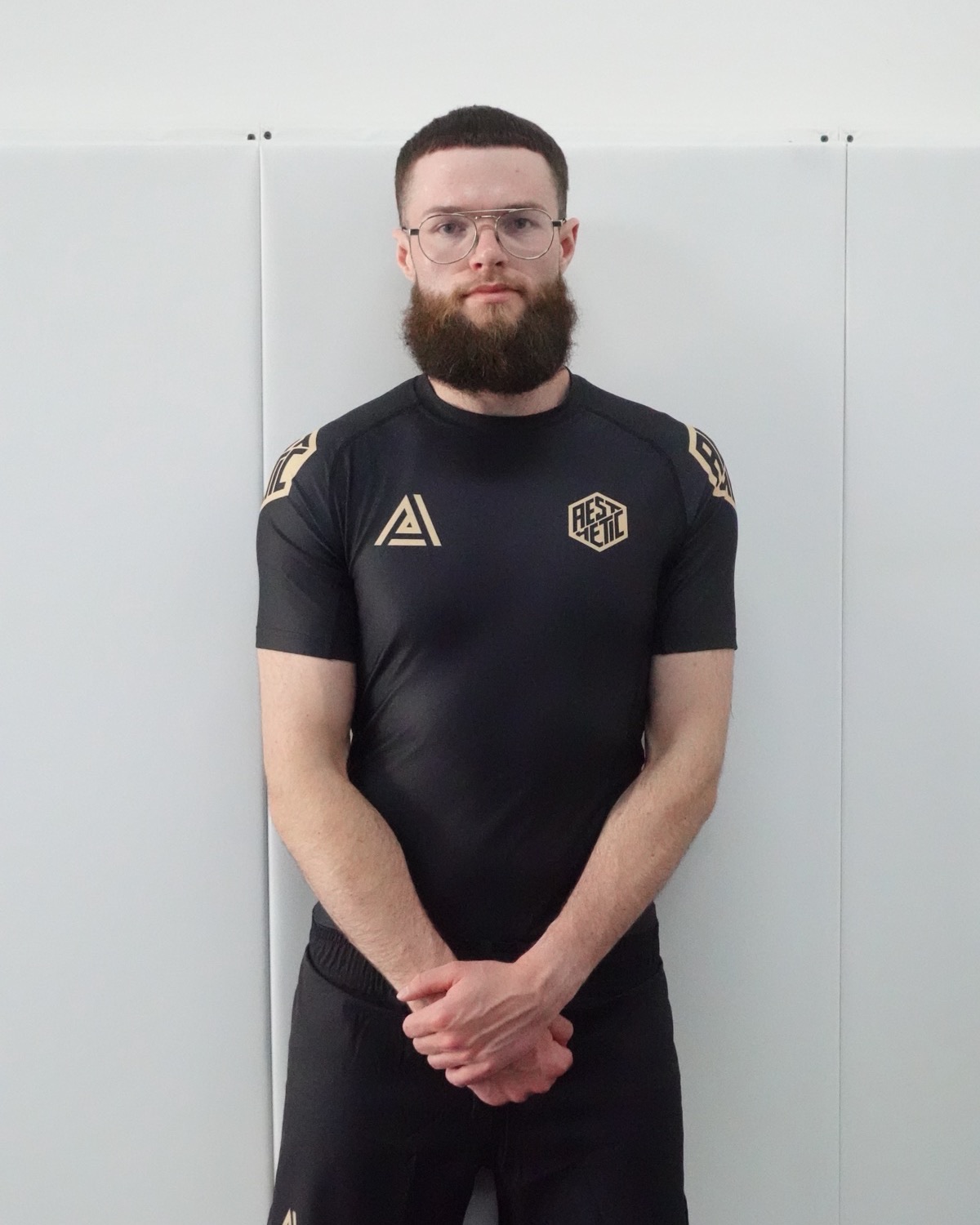 Elliot Ward, co-founder of Apex Jiu-Jitsu Atlanta, in a black and gold rashguard.