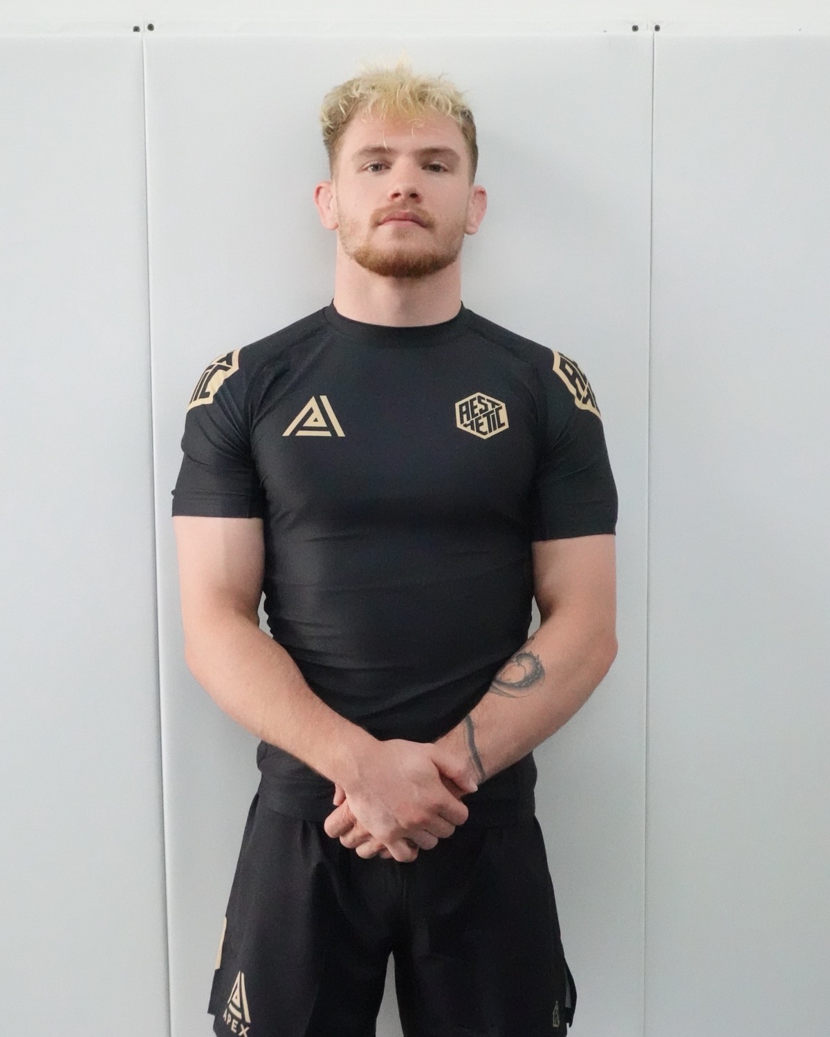Owen Jones, co-founder of Apex Jiu-Jitsu Atlanta, in a black and gold rashguard.